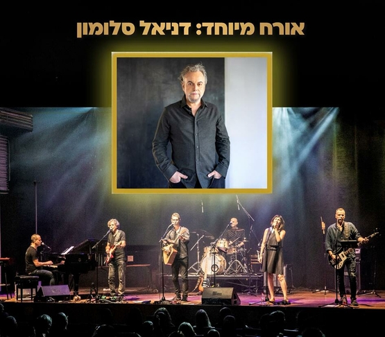 תמונת מופע: תמונה של להקה עם כלי נגינה שונים וברקע תמונה של דניאל סלומון